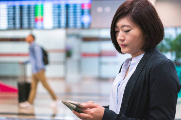 istock Confident businessman using smart phone at airport 1152994896