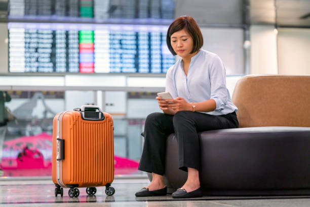 istock Businesswoman using phone while waiting in lobby 1152995545