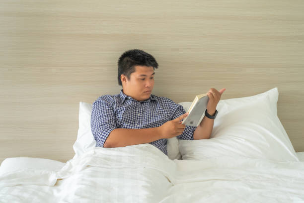 istock Businessman relaxing by reading book before bed time 1152995860