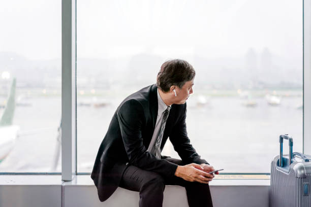 istock Businessman looking at runway through window 1152995866