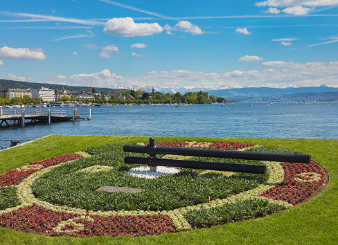 Zurich, Switzerland - May 31, 2019: Lake Zurich, summits of the Alps in the background, view from the city of Zurich. Lake Zurich is a lake in Switzerland, extending southeast of the city of Zurich, which is the largest city of the country and the capital of the Swiss canton of Zurich.
