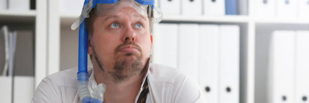 istock Man wearing suit and tie in goggles with snorkel 1152998191