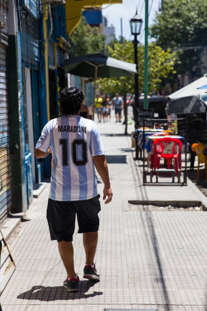 Man with Diego Armando Maradona dress at Caminito street in La Boca, Buenos Aires, Argentina Unidentified man with Diego Armando Maradona shirt at Caminito street in La Boca, Buenos Aires, Argentina. Maradona is argentinian former soccer player and one of the worlds most famous players la boca photos stock pictures, royalty-free photos & images