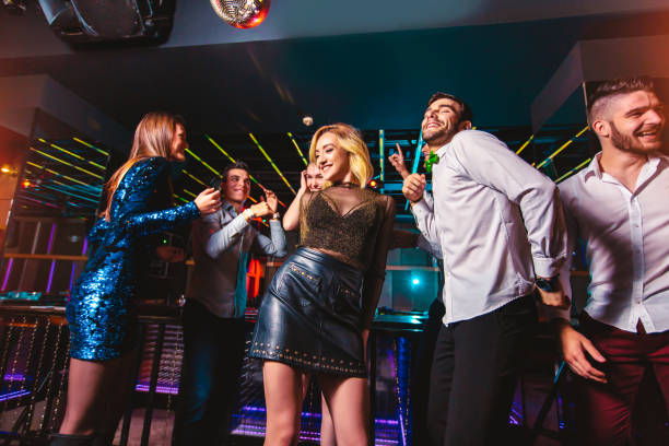 istock Young people dancing in night club 1153002577