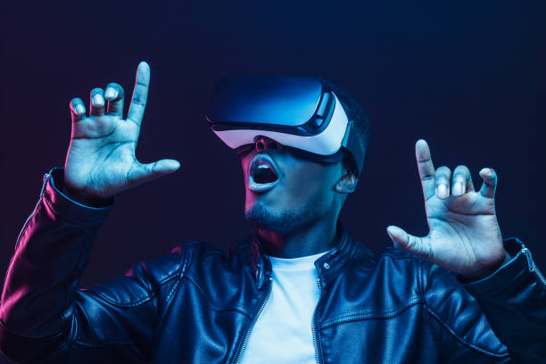 istock Young african american man having virtual reality experience using vr headset 1153003866