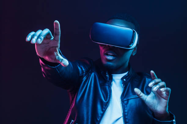 African man wearing virtual reality headset having great fun African man wearing virtual reality headset having great fun sense of science and technology stock pictures, royalty-free photos & images