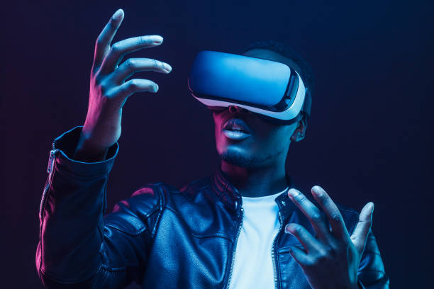 African man wearing virtual reality headset African man wearing virtual reality headset sense of science and technology stock pictures, royalty-free photos & images