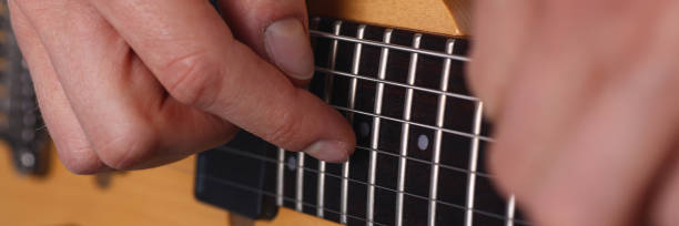 istock Male arms playing classic shape electric guitar 1153003944