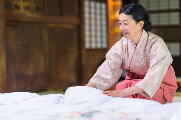istock Japanese inn worker tidying up room 1153003955
