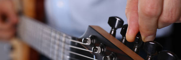 istock Male arms playing classic shape electric guitar 1153003965