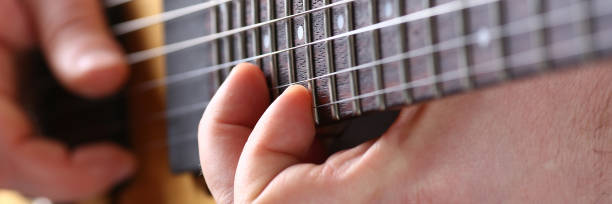 istock Male arms playing classic shape electric guitar 1153003970