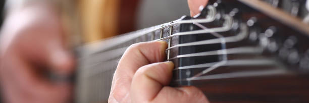 istock Male arms playing classic shape electric guitar 1153003975