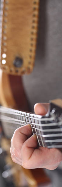 istock Male arms playing classic shape electric guitar 1153003979