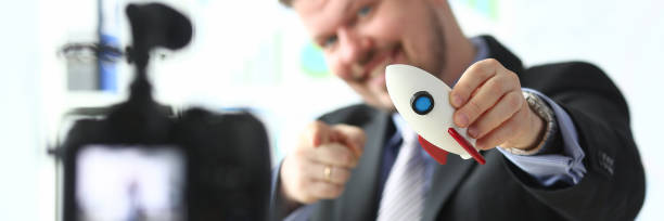 Businessman hold rocket in hand closeup
