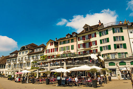 Unidentified people sitting in restaurants in Rapperswil, Switzerland. This town located on the upper end of Lake Zurich is popular tourist destination.