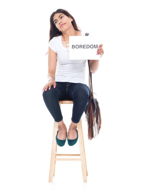 istock Beautiful latino female sitting on a stool who is bored 1153008464