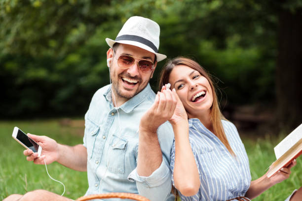 istock Smiling happy young couple having a great time on a picnic 1153008860
