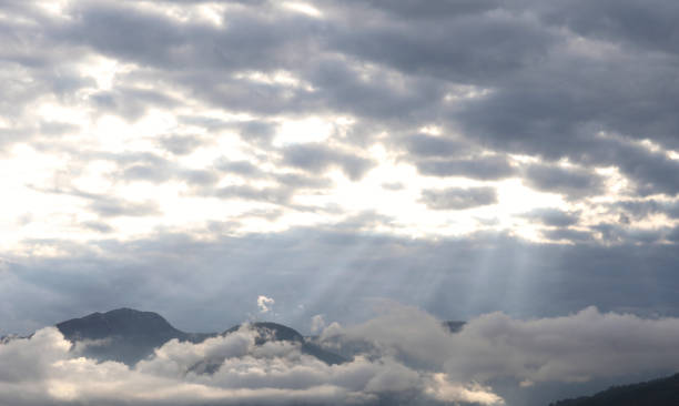 istock View of sunlit mountains and clouds 1153009437