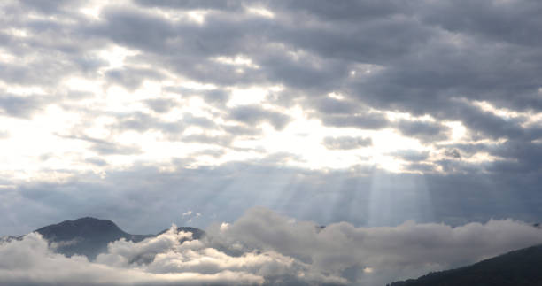 istock View of sunlit mountains and clouds 1153009439