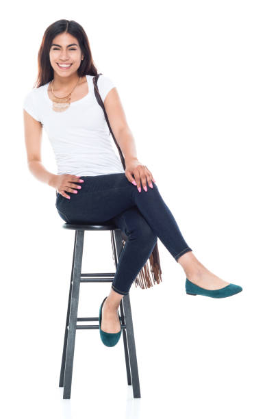 istock Good looking female sitting on a black stool and is happy 1153011345