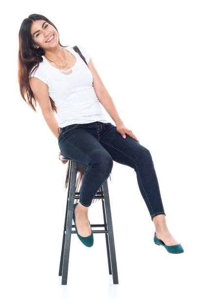 istock Good looking female sitting on a black stool and is happy 1153011370