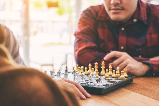 istock Closeup image of a man moving and playing chessboard game together 1153011500