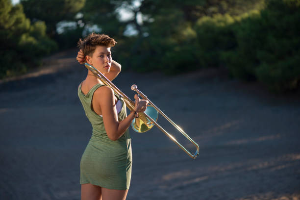 istock Young woman playing trombone 1153013729