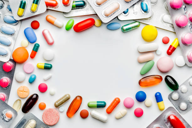 istock Large group of assorted capsules, pills and blisters making a frame on white background 1153015495