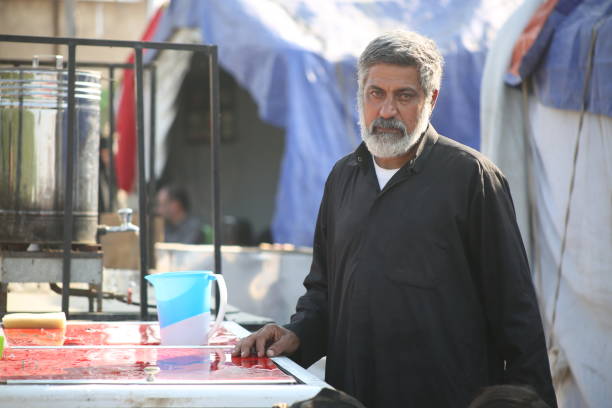 A man volunteers to give water to the people participating in the Arbaeen walk in Iraq.