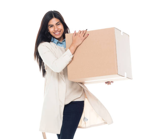 istock Attractive young latino female is holding a box 1153018645