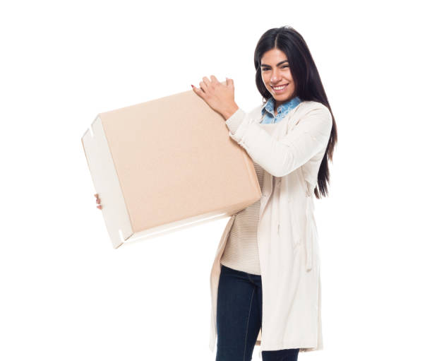 istock Attractive young latino female is holding a box 1153018651
