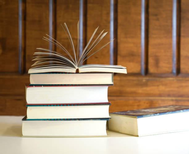 Stack of books Open textbook on top of books with wood background, an education concept opportunity dictionary definition stock pictures, royalty-free photos & images