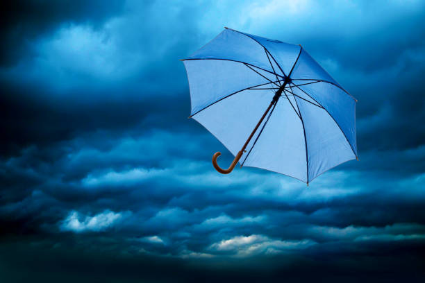 istock blue flying umbrella against a blue cloudy sky 1153019544