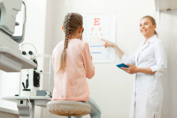 istock Beaming good-looking doctor pointing on a poster with letters 1153021692
