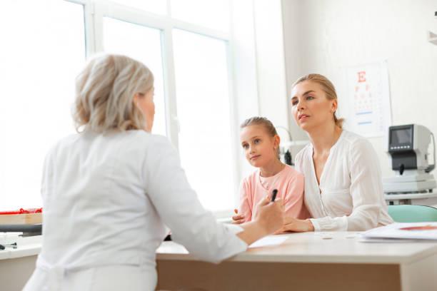 istock Focused blonde lady hugging her daughter while listening 1153021754