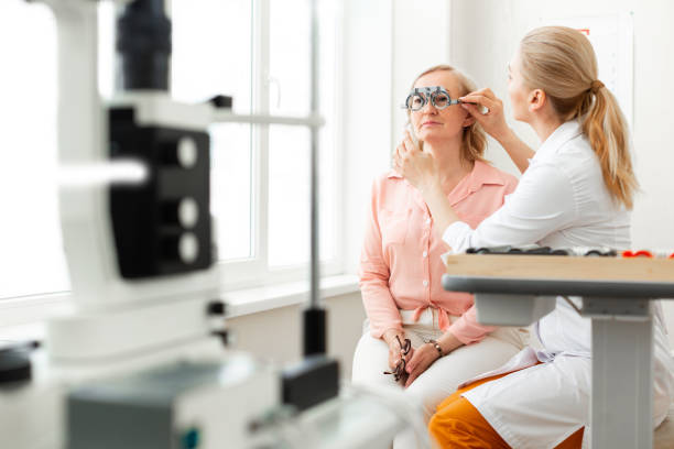 istock Gentle long-haired doctor correcting placement of glass device 1153021779