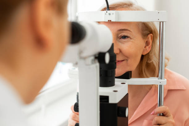 istock Diligent calm woman accurately putting her face into special frame 1153021788