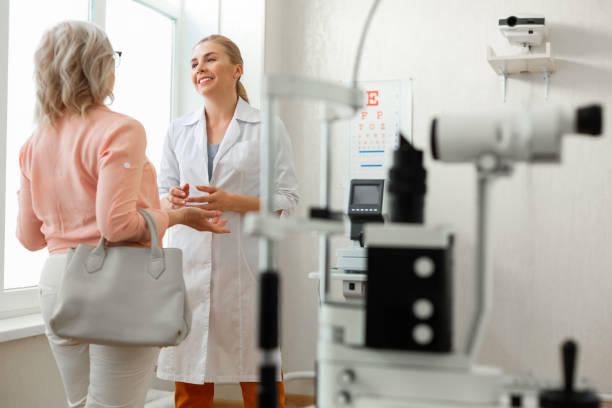 istock Pleasant kind doctor in long white robe talking to patient 1153021856