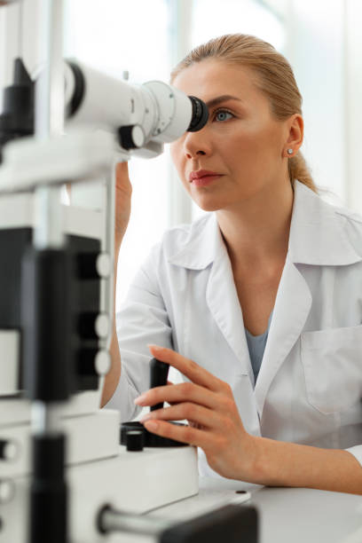 istock Serious good-looking woman with blue eyes looking in binocular 1153021881