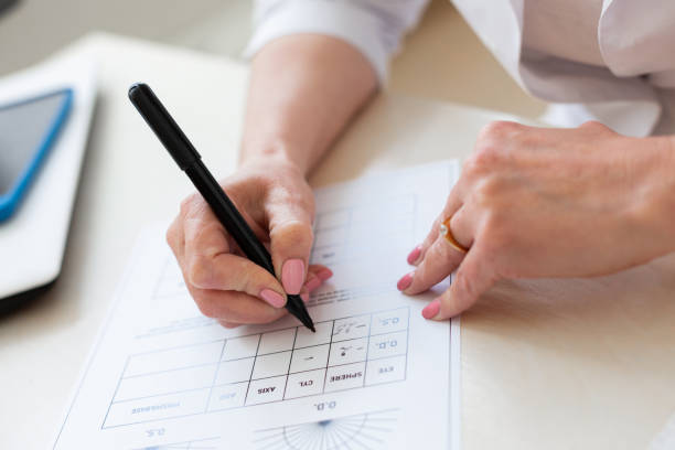 istock Attentive doctor with pink nails listing indicators of poor vision 1153021900