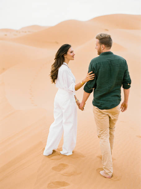 istock Loving couple in Sahara Desert. 1153022132