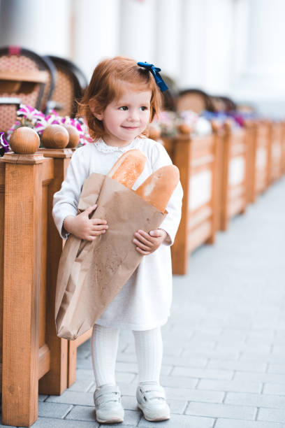 istock Girl with fresh bread 1153024069