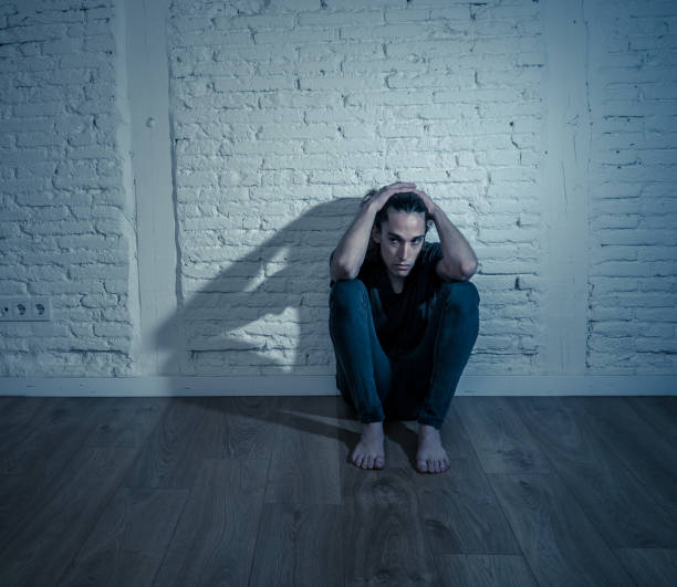 istock Devastated depressed millennial man crying sad feeling hurt suffering Depression. Teenager victim of bullying feeling lonely and depressed alone at home. Emotional pain Loneliness and Heartbroken. 1153024216