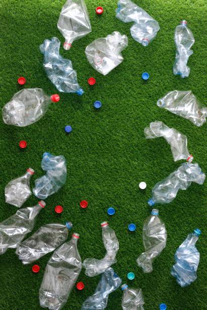 istock The concept of recycling plastic and environmental protection. Pet preforms for plastic bottles on the green grass. Artificial turf. 1153025226