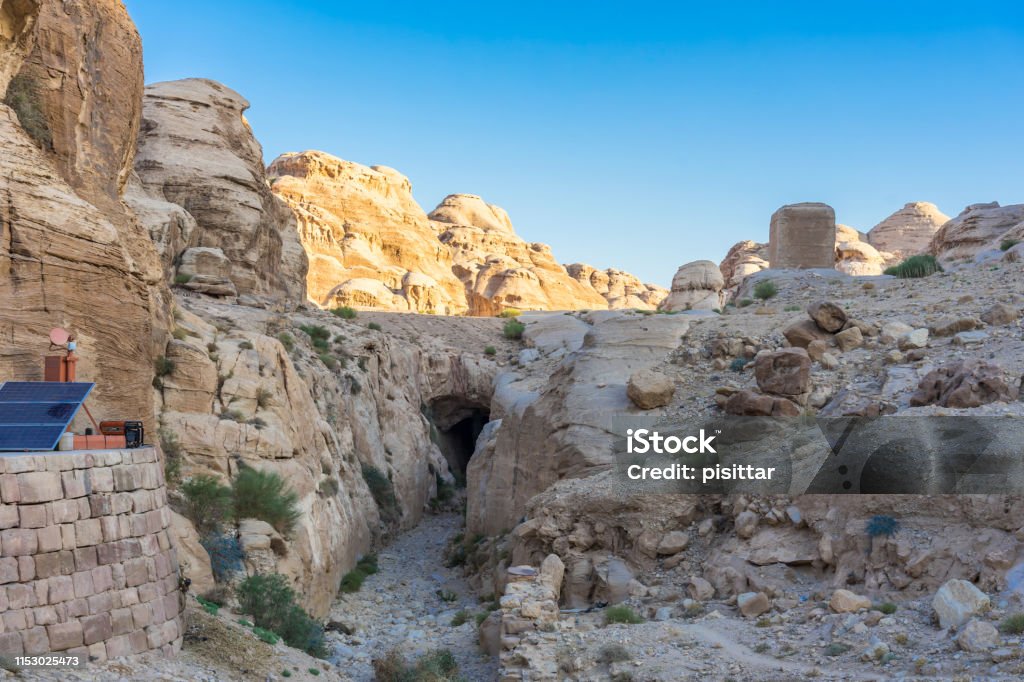 The Siq - narrow slot-canyon, entrance passage to Petra (Red Rose City), Jordan. UNESCO world heritage site Ancient Stock Photo