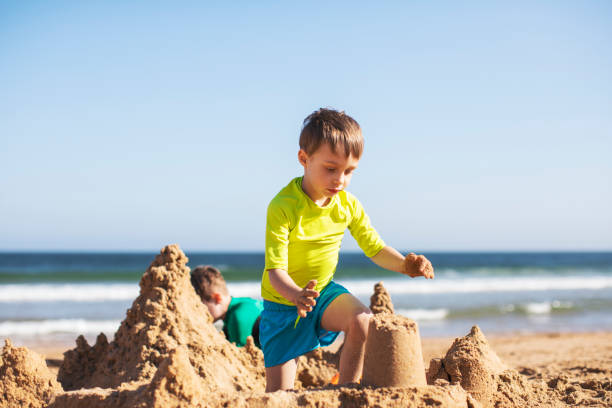 istock Kids building sand castle 1153026146
