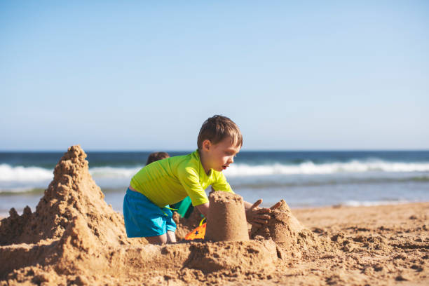 istock Kids building sand castle 1153026474
