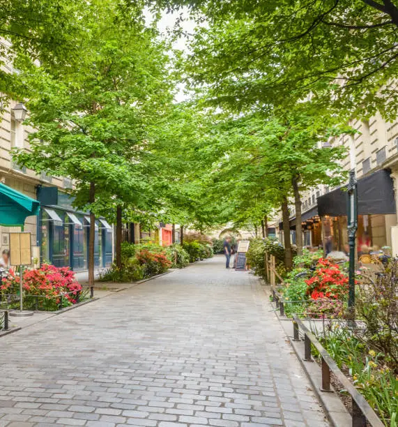 A quiet street with restaurants in the bohemian Marais district of Paris.