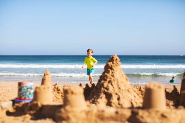istock Kids building sand castle 1153030015
