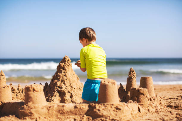 istock Kids building sand castle 1153030590